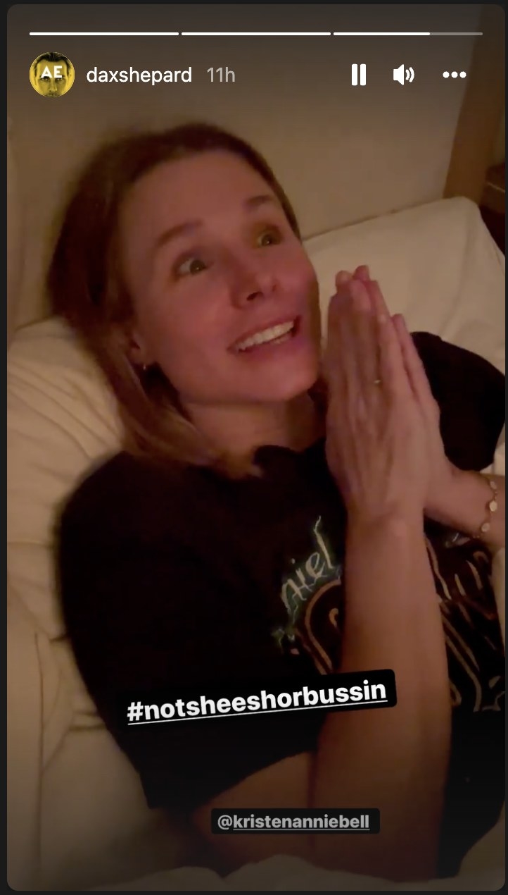 Kristen Bell grimacing and holding her hands together