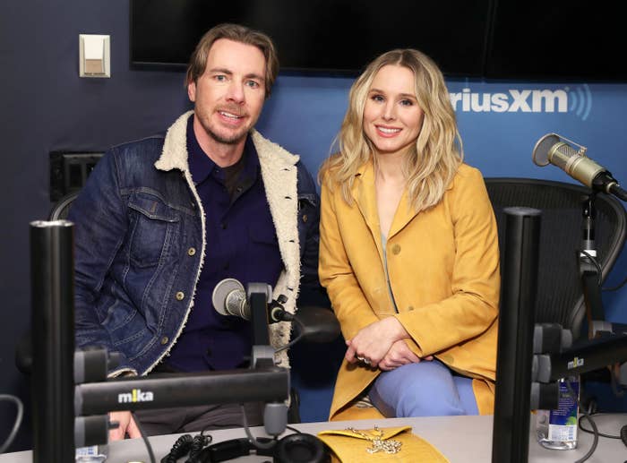 Dax Shepard and Kristen Bell sitting in front of microphones in a SiriusXM studio