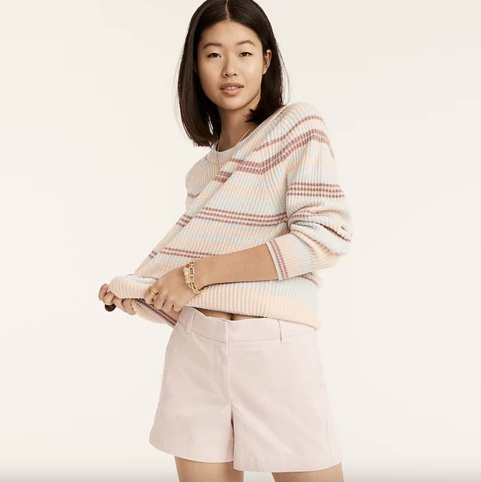 A model in a sweater and shorts