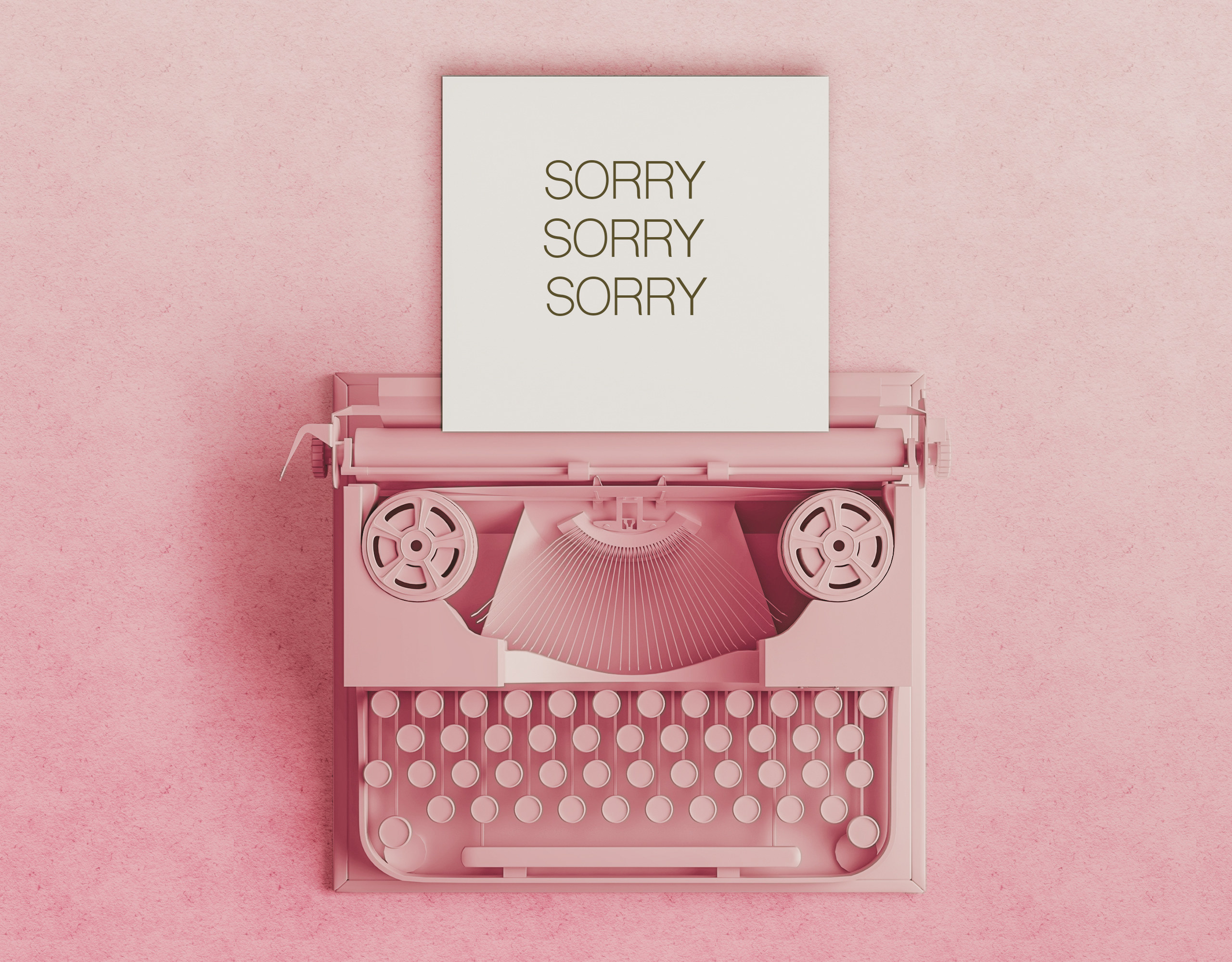 A typewriter with paper that says &quot;sorry, sorry, sorry&quot;