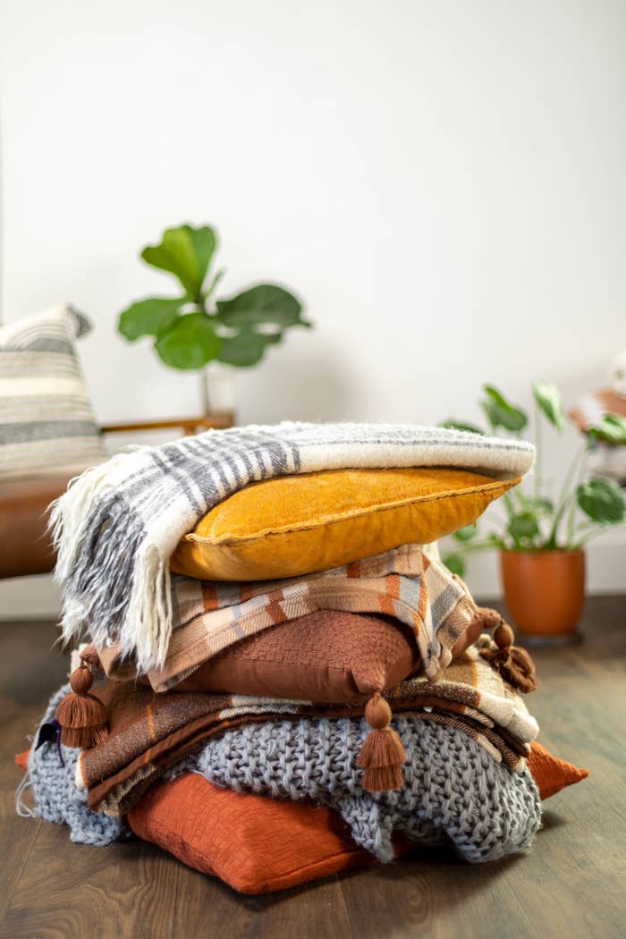 pillows and blankets stacked on each other