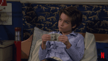 kid holding $20 bill