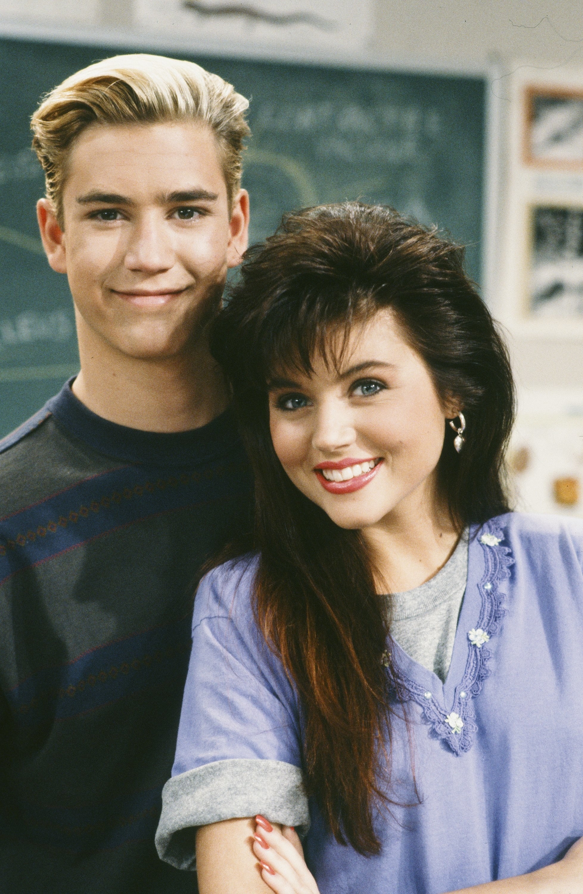 Mark-Paul Gosselaar as Zack Morris andTiffani Thiessen as Kelly Kapowski smile in an onset photo from October 1991