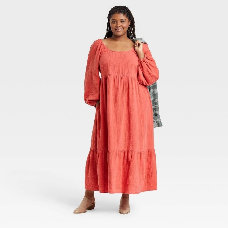 Model in pink long sleeve dress