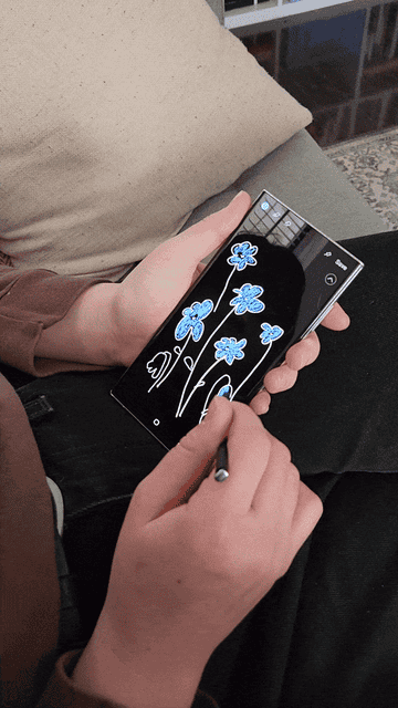 handing using stylus to draw flowers on the phone