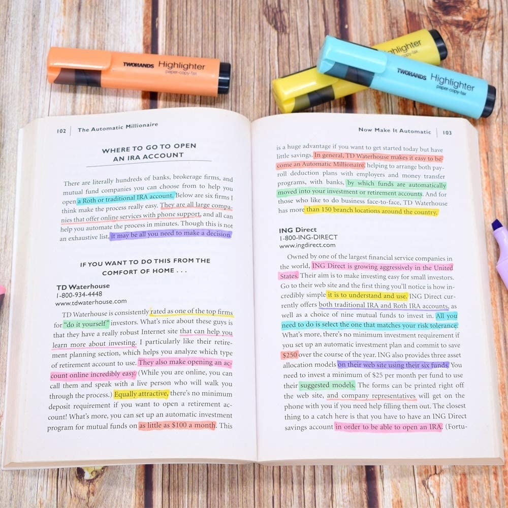 A book open with different sentences highlighted and underlined using all of the colours of markers