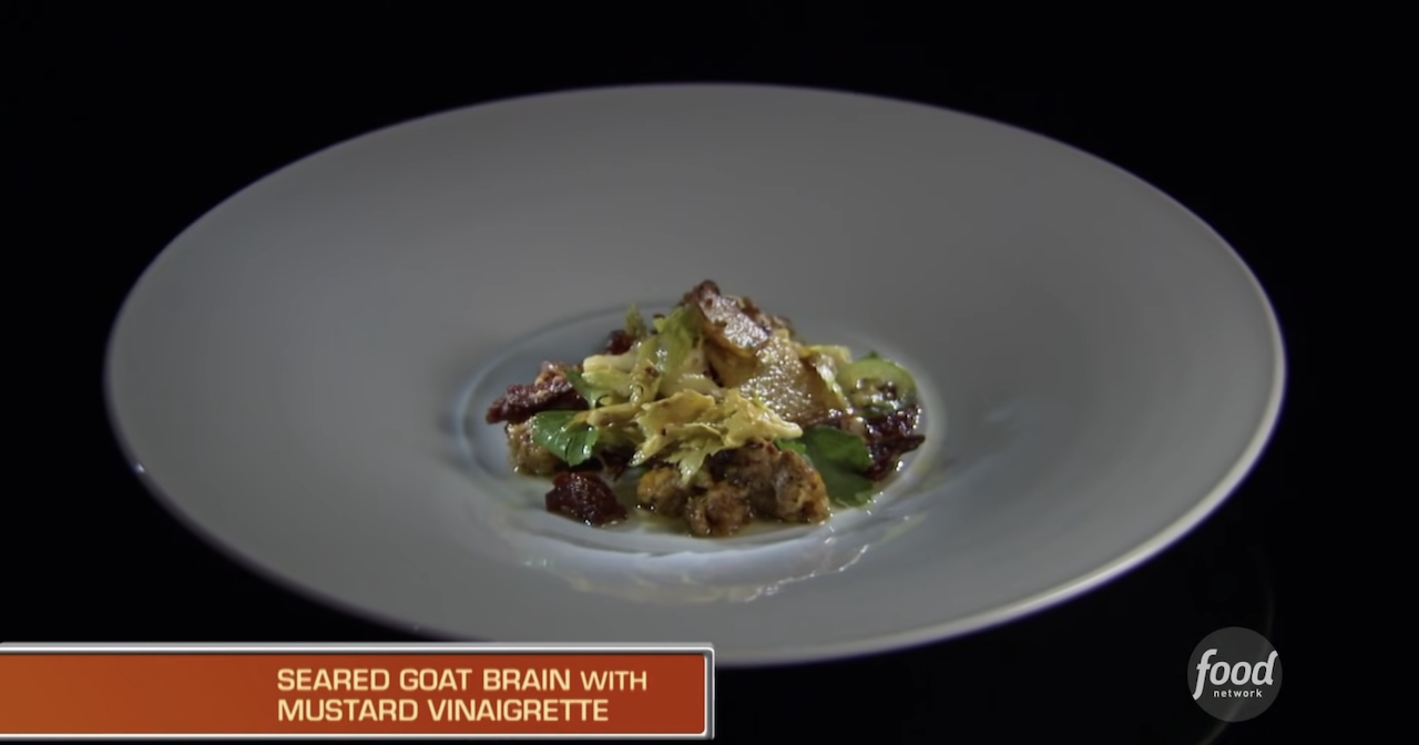 A plate of seared goat brain with mustard vinaigrette.