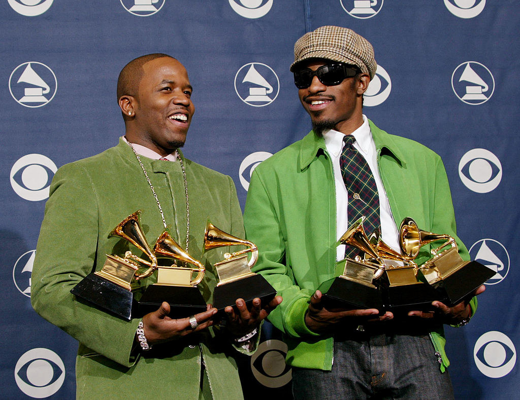 Each member holding three Grammys each as they smile