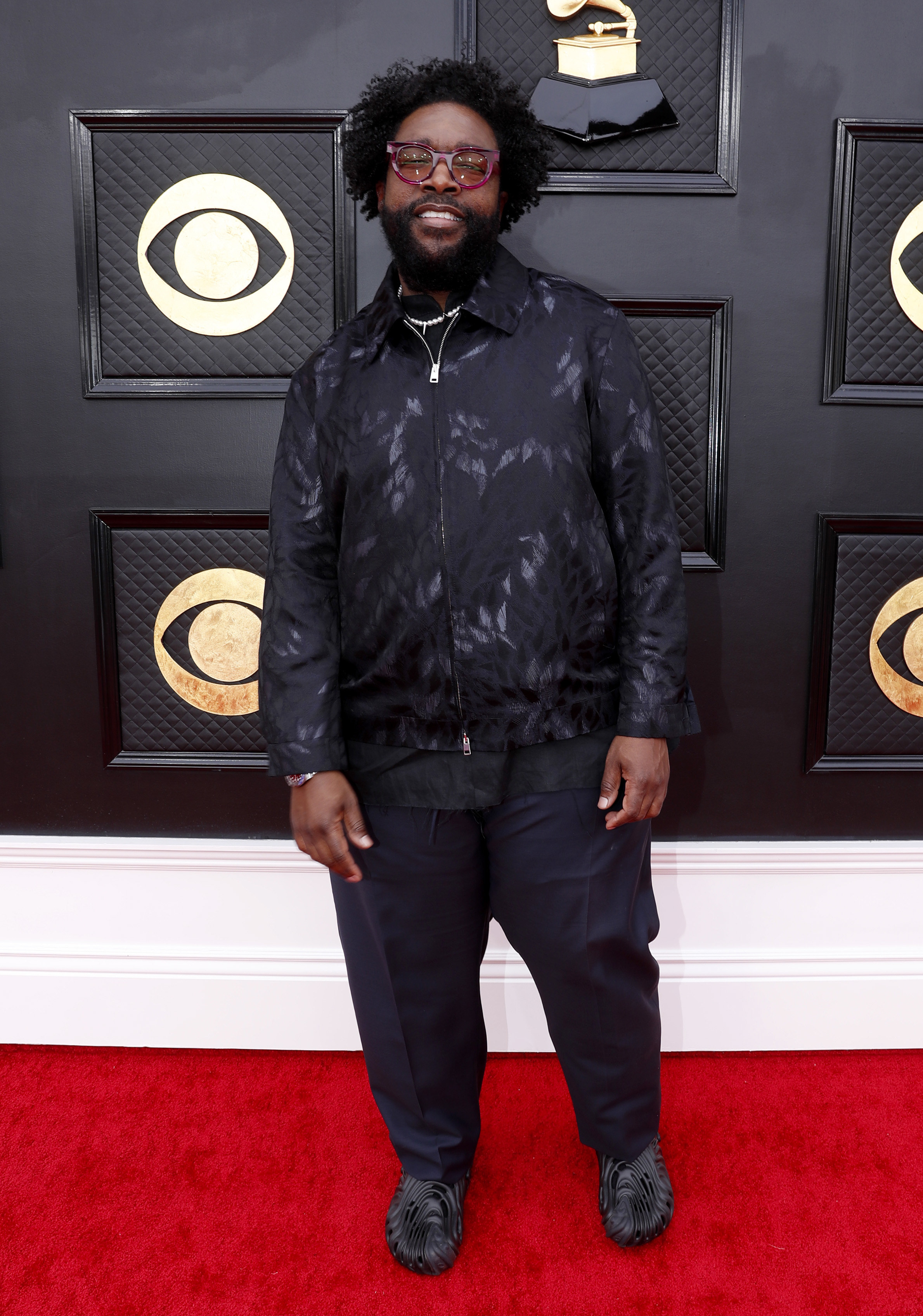 Questlove smiles at the Grammys red carpet
