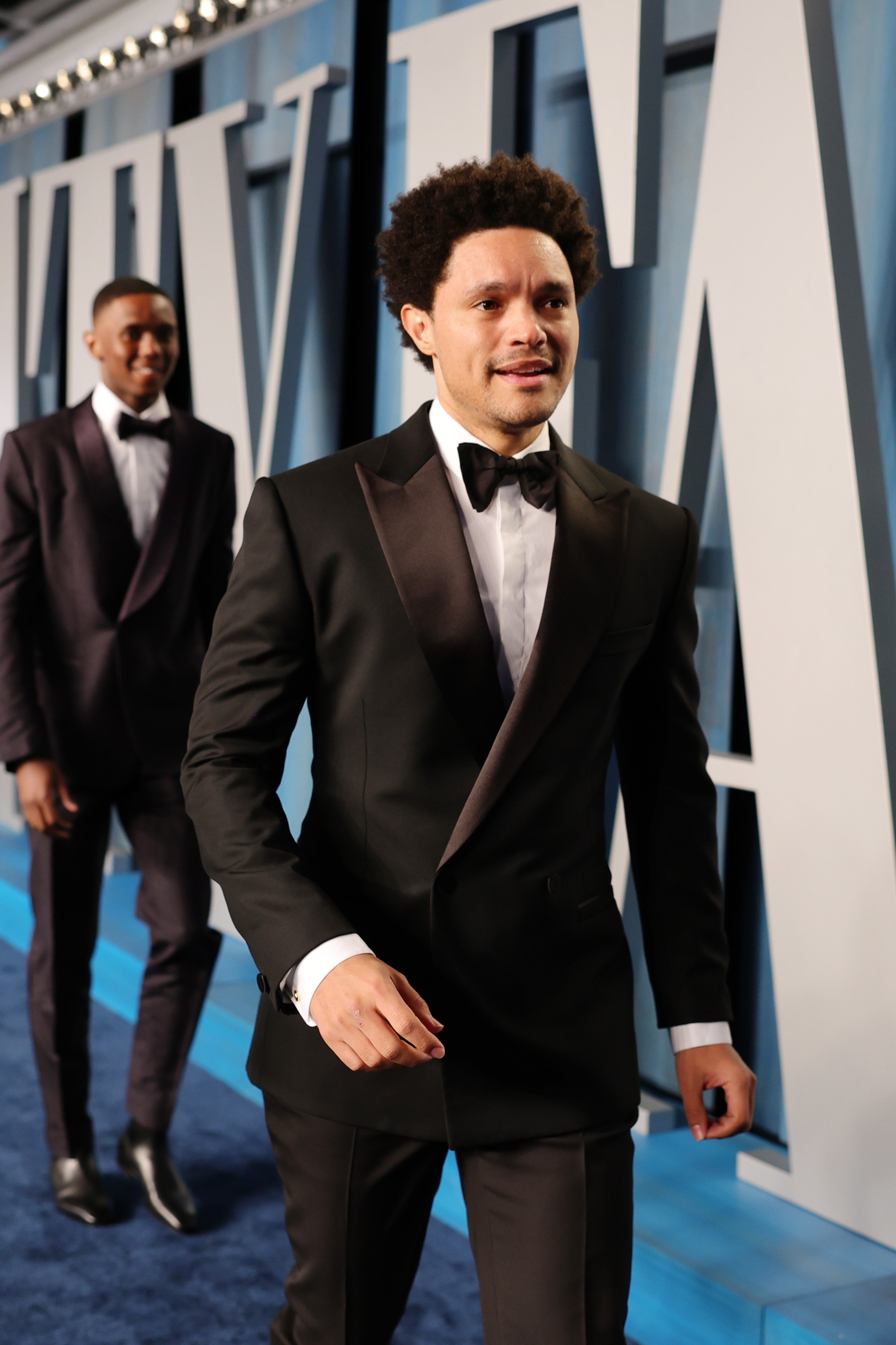 Trevor walks while wearing a tuxedo