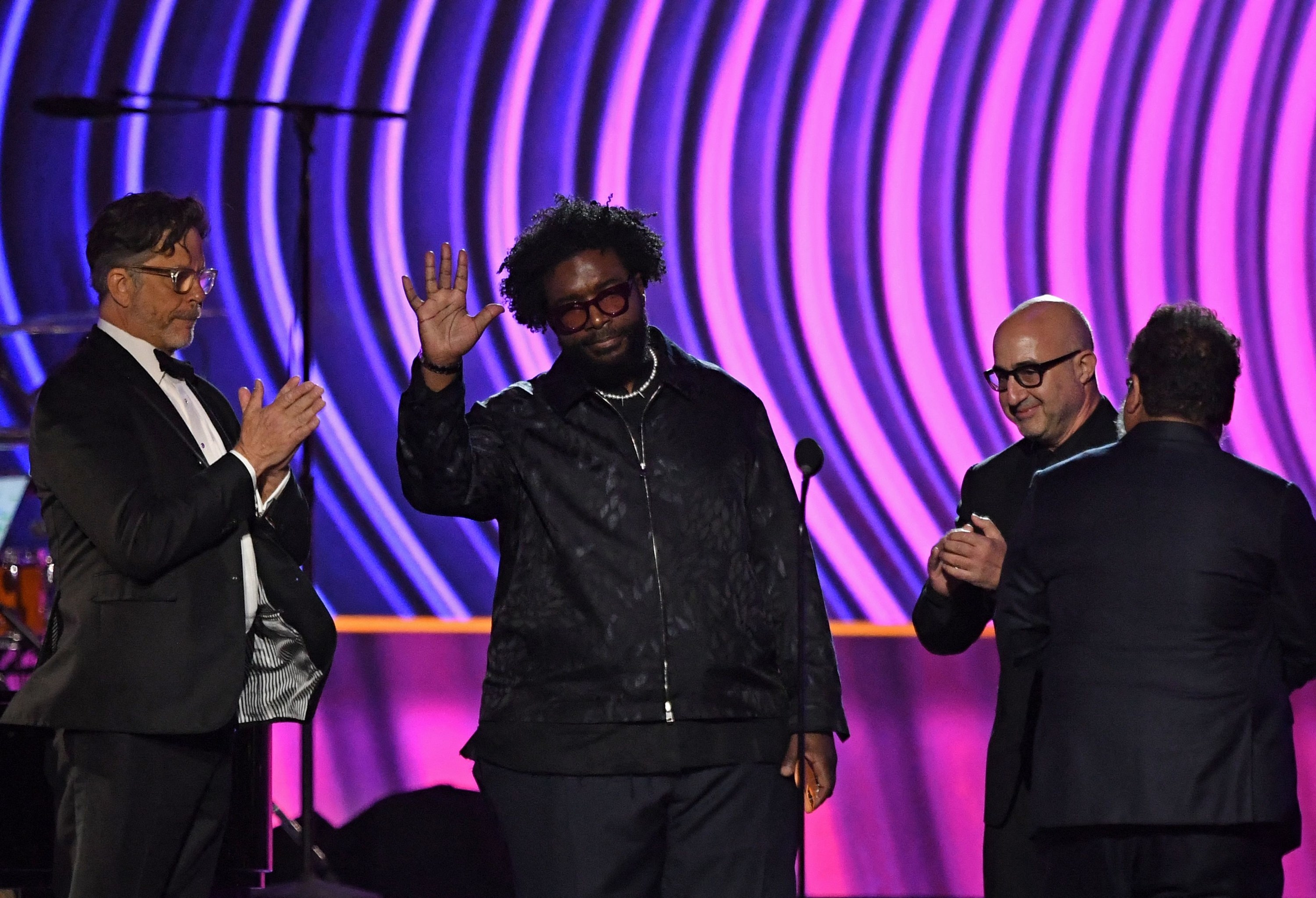 Questlove waves to the crowd onstage