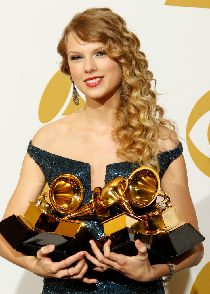 Taylor holding up her awards