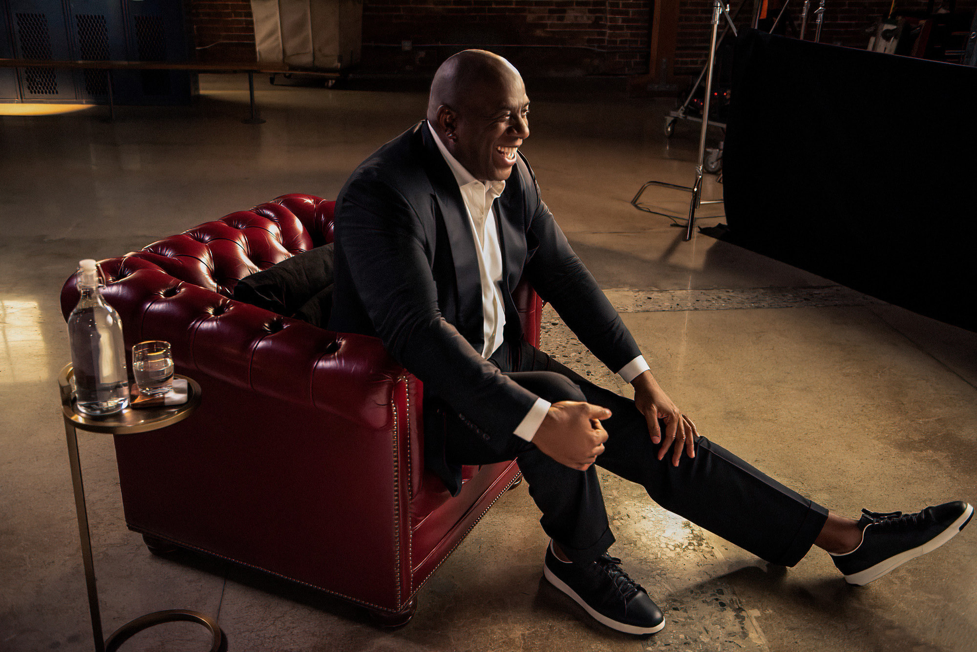 Magic Johnson sits in a red chair