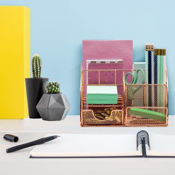 the desk organizer on a desk filled with office supplies