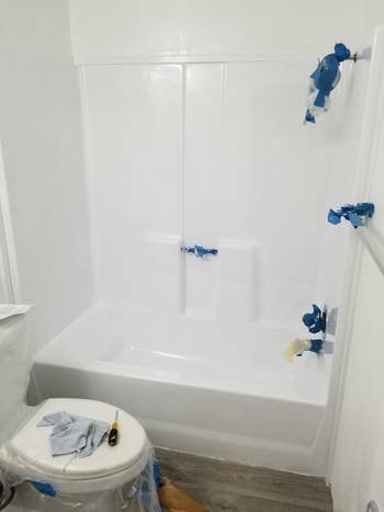 after: the same tub and surround, now shiny white
