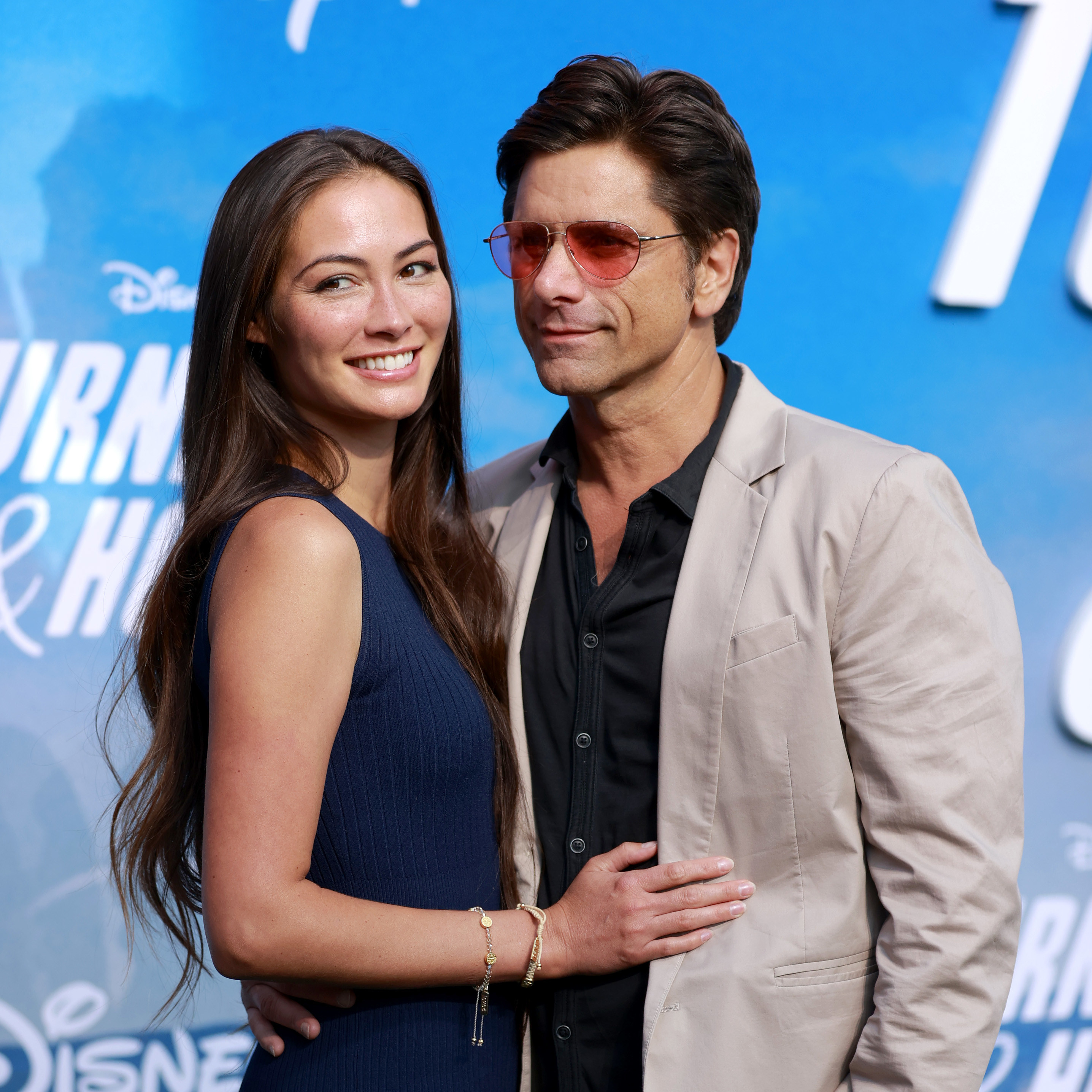 Caitlin McHugh and John Stamos attend the Disney+ &quot;Turner &amp; Hooch&quot; Premiere at Westfield Century City Mall on July 15, 2021