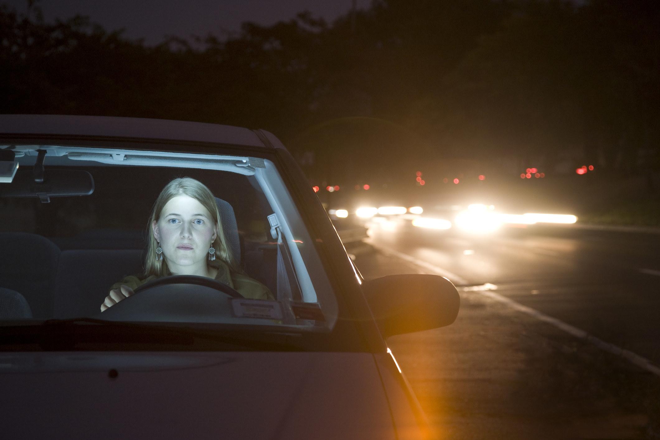 A woman driving at night