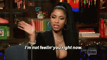 Nicki Minaj is seen waving her hand irritated.