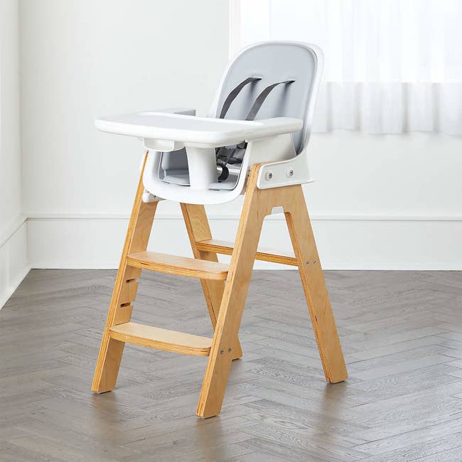 The gray high chair with wooden legs