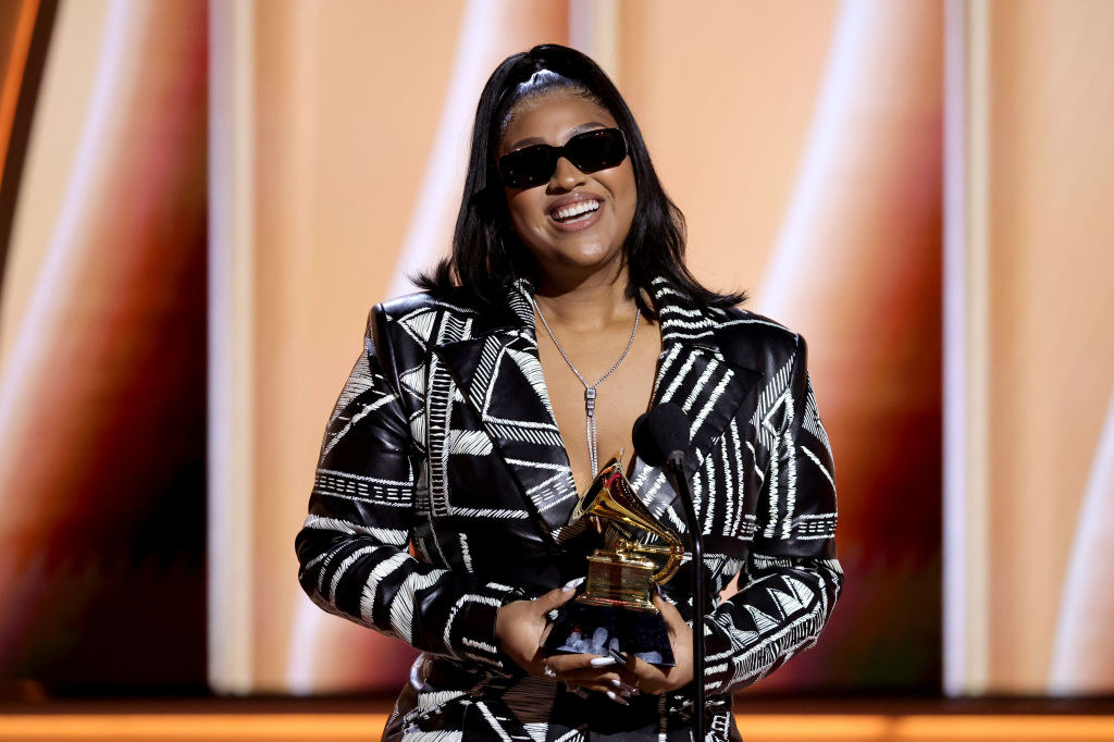Jazmine holding a Grammy