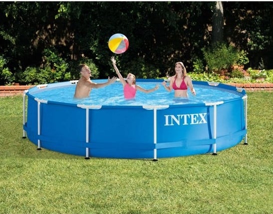Adults and child playing in pool