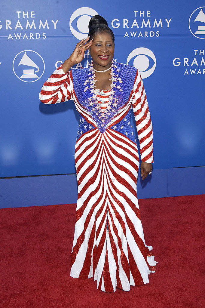 Wearing a US flag–themed gown and saluting