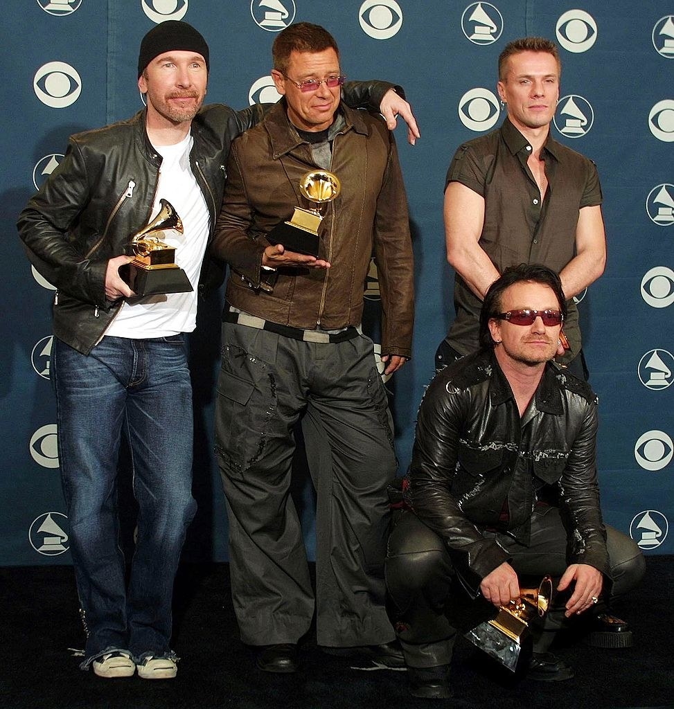 Holding their Grammys and wearing leather jackets or a short-sleeved T-shirt and jeans or leather or loose pants