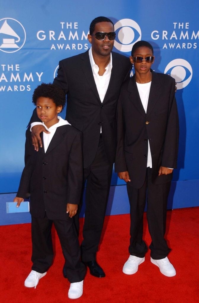 In a suit and with two young boys, in matching suits
