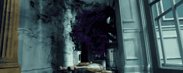 Morbius jumping between two walls in a hallway, with black and purple smoky lines trailing behind him