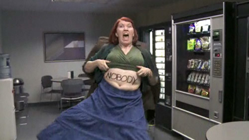 Kate Flannery as Meredith Palmer with her shirt lifted up revealing the word &quot;nobody&quot; on her stomach