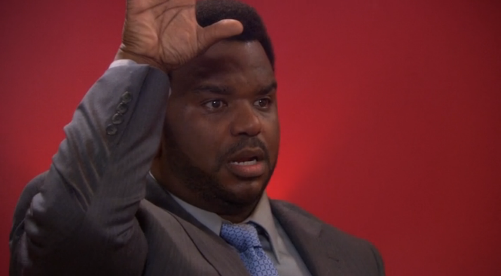 Craig Robinson as Darryl Philbin staring wide eyed with his hand up after shooting a basketball