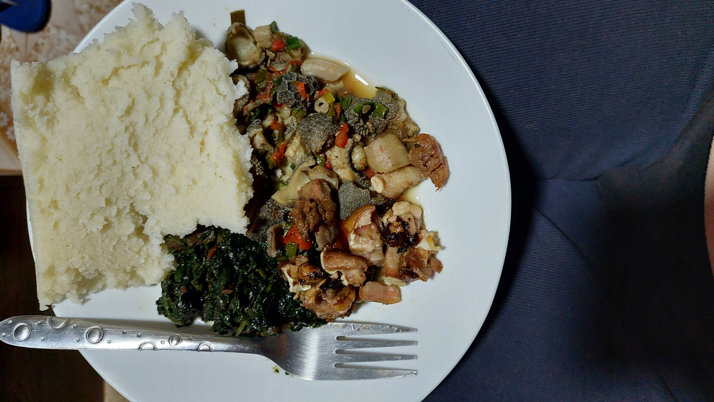 Ugali and other Kenyan foods on a plate