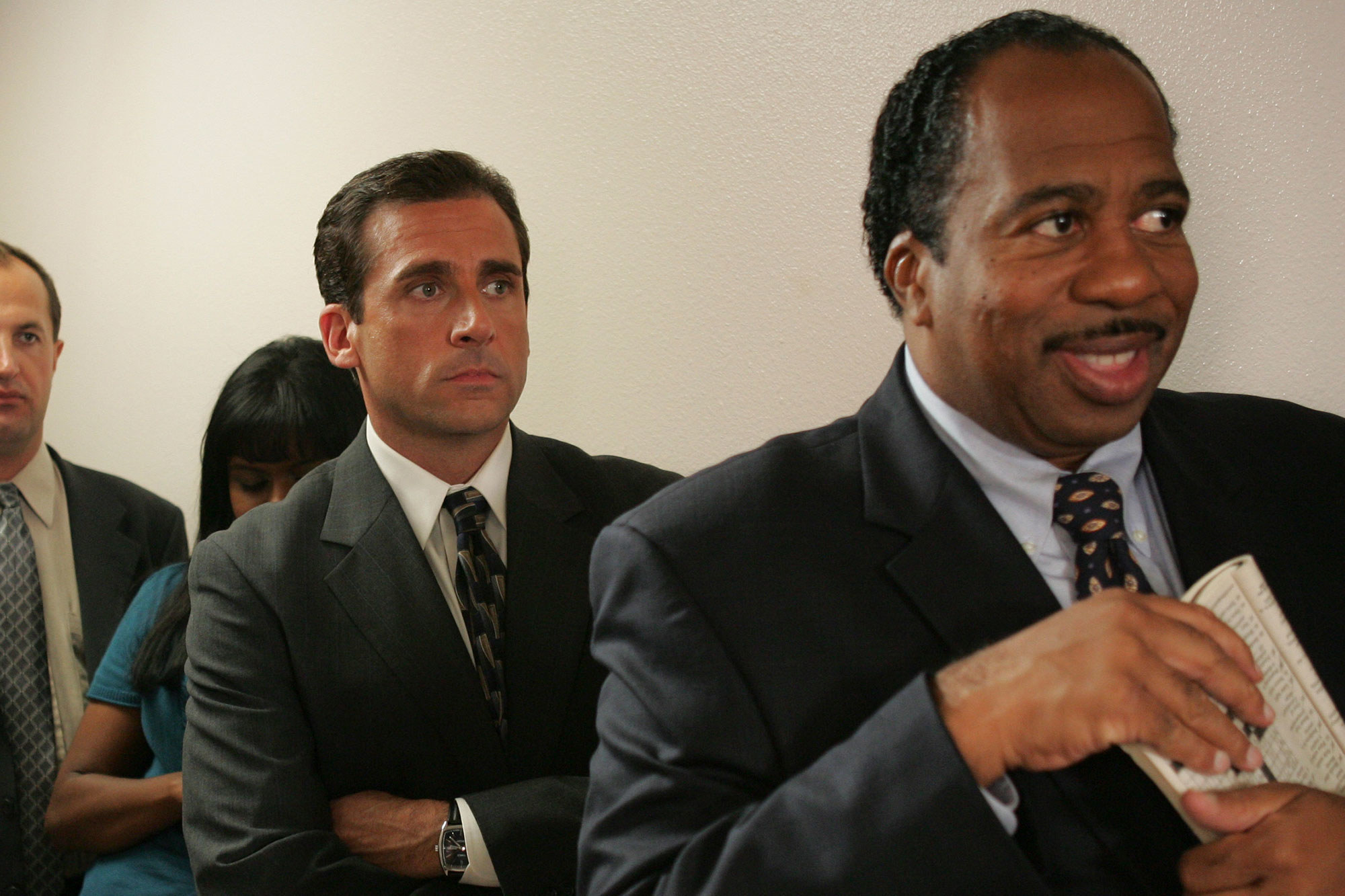 Leslie David Baker as Stanley Hudson smiling in the queue for a pretzel