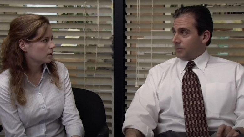 Steve Carell as Michael Scott awkwardly looking at Jenner Fischer as Pam Beesly