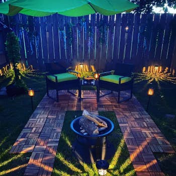 reviewer's outdoor space with chairs, fire pit, and multiple interlocking Teak tiles