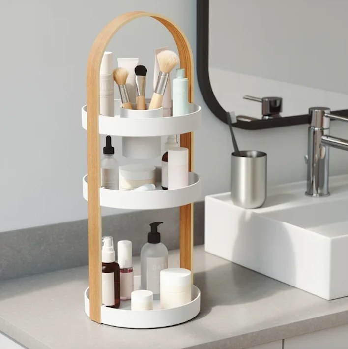 Organizer on a sink, filled with make up and skincare products