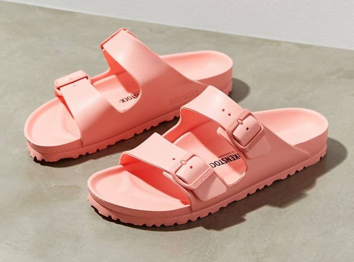 the pink plastic sandals on a concrete floor