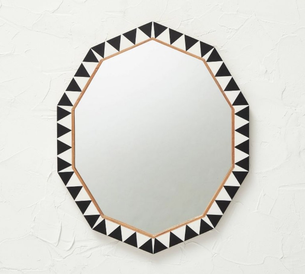 A decorative wood resin wall mirror
