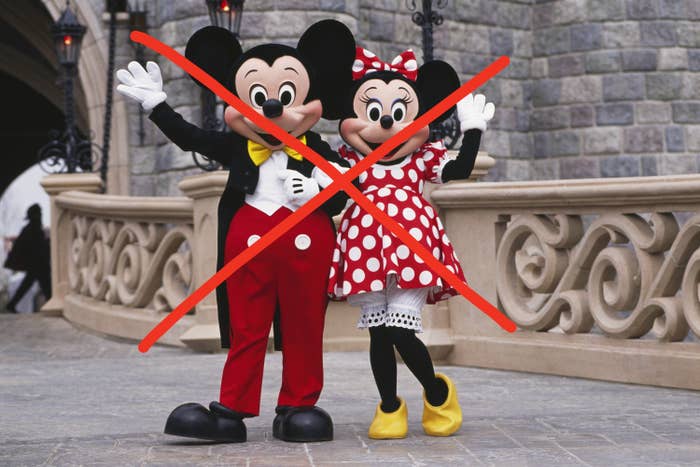 people in minnie and mickey costumes at disney world with an X drawn over them
