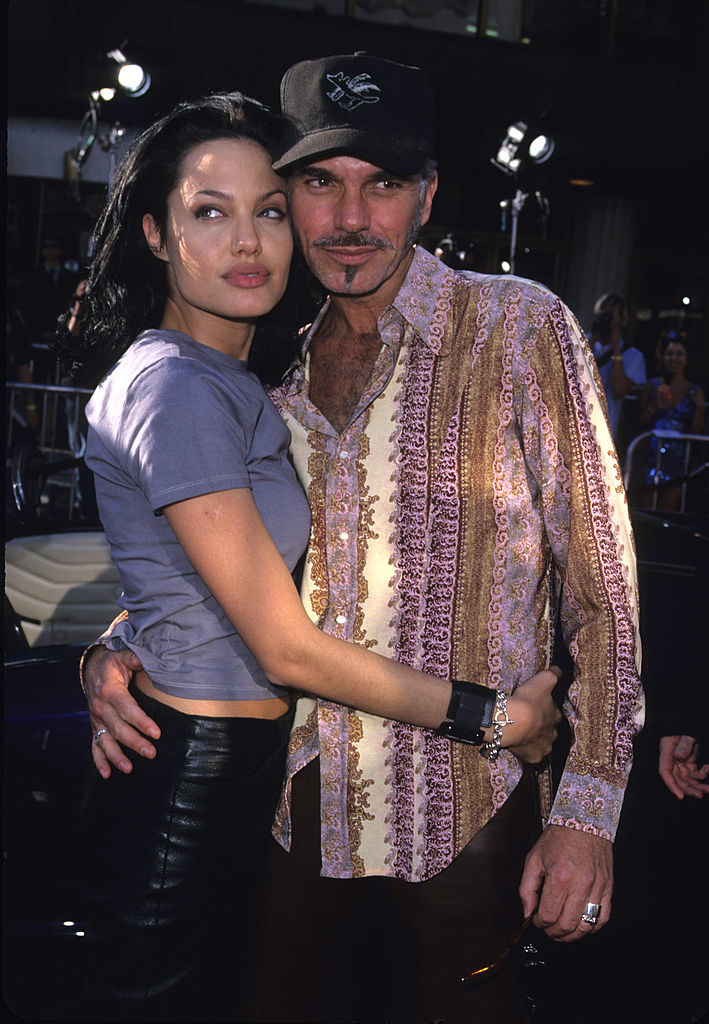 Angelina with her arms around Billy Bob as they pose on the red carpet