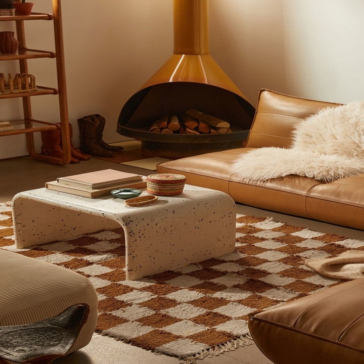 the brown and white checkerboard rug in a decorated living room