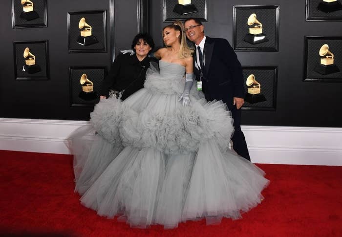 Ariana Grande poses in a strapless tulle dress with her mom and dad on each side of her