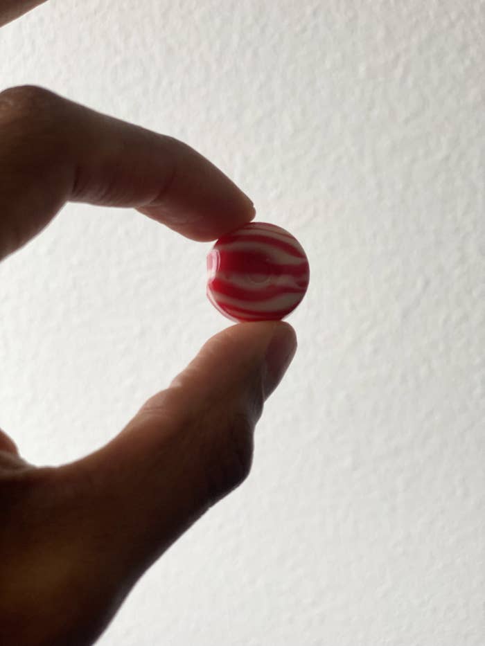 white and pink swirls on a small circular hard candy