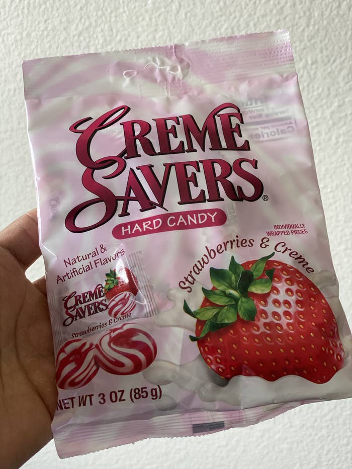 medium sized bag with photos of the hard candy next to a strawberry being dunked in milk