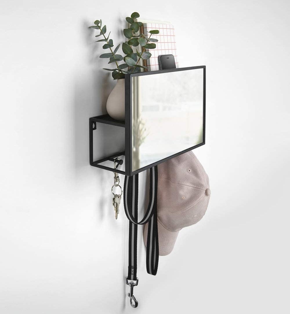 the rectangular wall mounted mirror with hooks and a hidden shelf