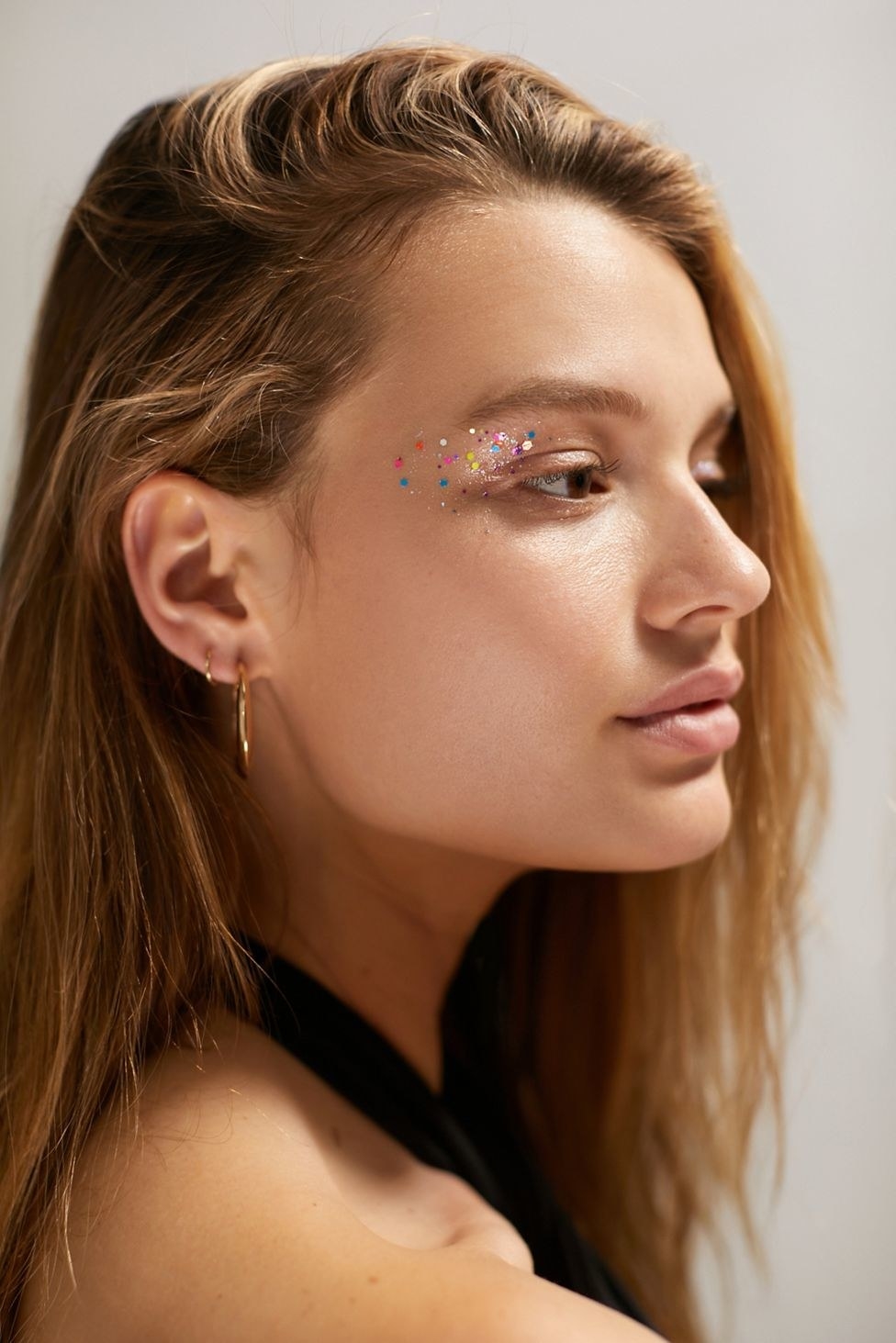 a model with the multicolored glitter on their eyelid