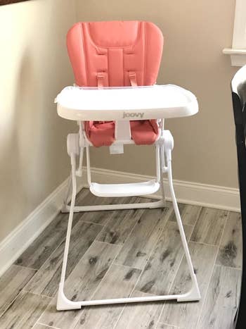 reviewer's photo of the high chair in coral