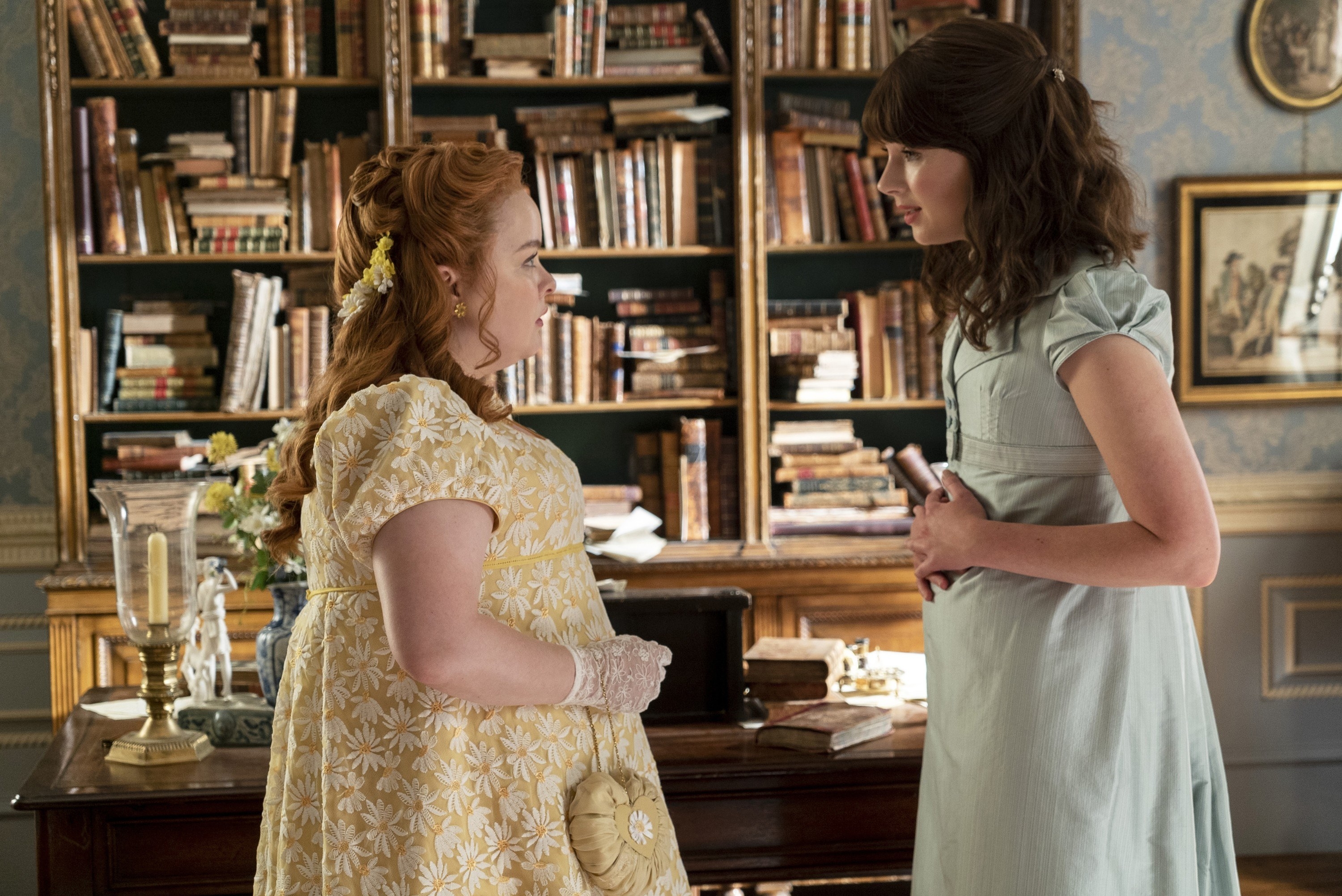 Penelope and Eloise talking in a study