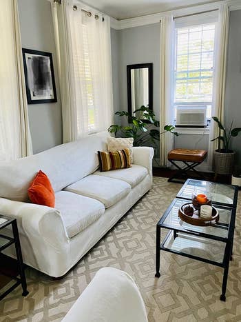 a white couch (with the slipcover on) in a living room