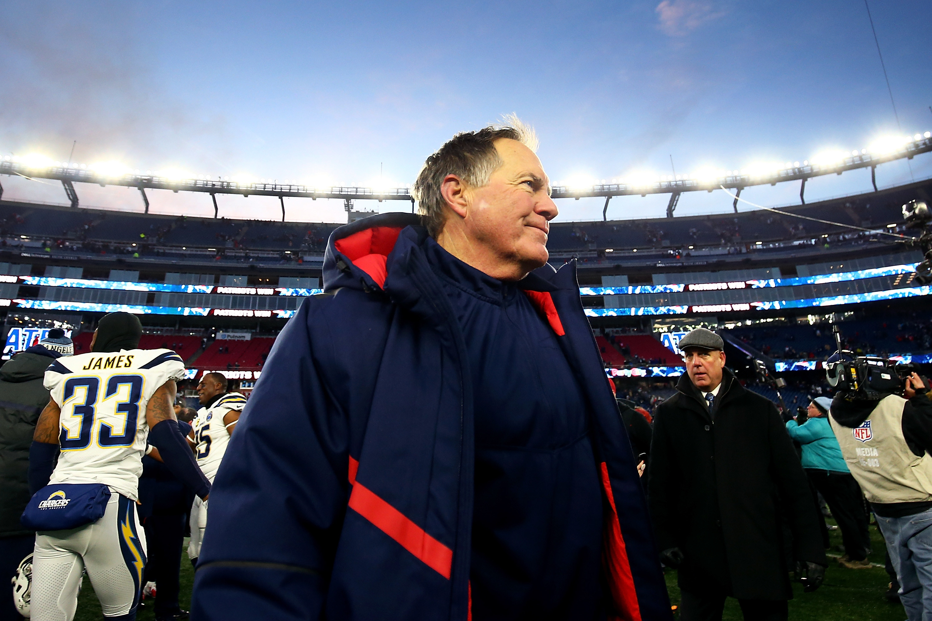 Bill Belichick in a big blue and red coat